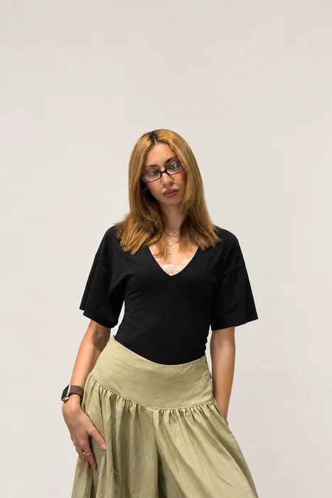 Portrait in a black top and green skirt